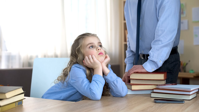 Offended little girl neglecting homework, ignoring daddys remarks, conflict