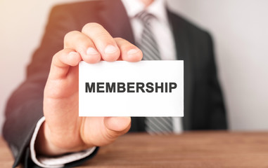 Businessman holding a card with text Membership