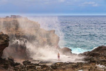 Fototapeta na wymiar Tourists looking at a blow hole on Maui, Hawaii, USA