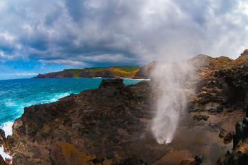 Pacific ocean waves hitting the rocky coastline of Maui, Hawaii, USA