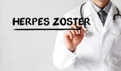 Doctor writing word HERPES ZOSTER with marker, Medical concept