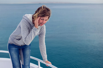 Cruise sea motion sickness tourist woman seasick on boat vacation with headache or nausea. Fear of...