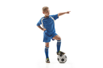 Young fit boy with soccer ball standing isolated on white. The football soccer player on studio background.
