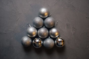 Christmas tree made by silver Christmas balls on the dark background with copy space