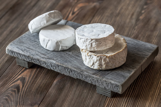Heads of Camembert on the wooden board