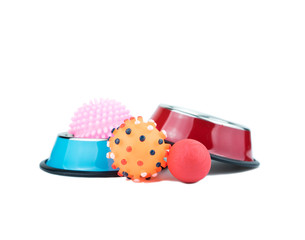 Pet supplies concept.  Rubber toy and stainless bowls isolated on white