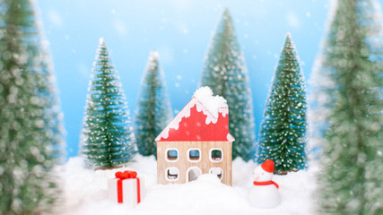 Landscape forest with christmas trees and house on the snow in winter. Concept of christmas holiday celebration and new year