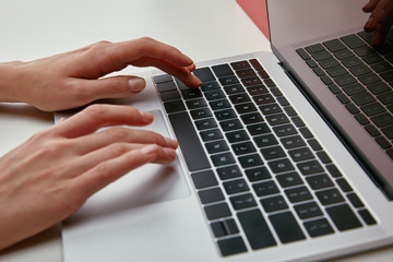Close up of woman hands typing on laptop keyboard