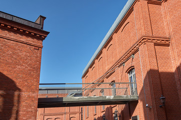 The metal railing and brick wall in an old brewery in Poznan.. © GKor