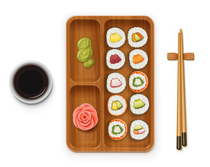 Set sushi rolls with various ingredient on wooden tray.