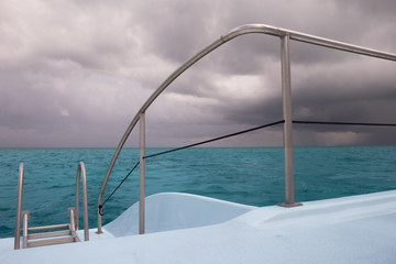 Fototapeta na wymiar Close up of a part of a Catamaran sailing on the Caribbean Sea on a overcast day by Grand , Cayman Islands