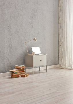 Modern room corner style with grey wall, grey cabinet and book. Laptop style.