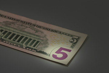 number 5 on banknote american dollar