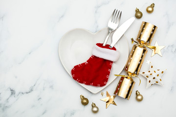 Christmas meal flay lay. Festive table setting with cracker and stocking