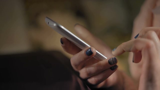 Close-Up, Woman's Hands Flipping Pages on a Smartphone