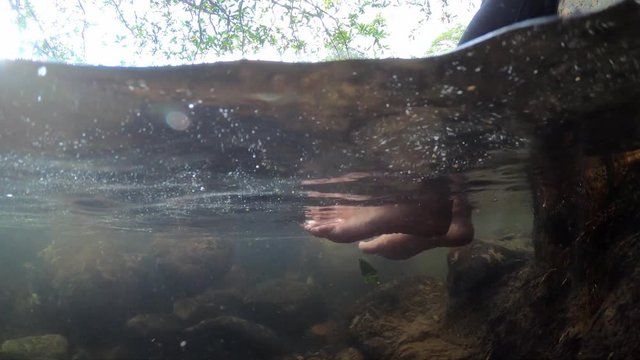 Bare foot soak in the waterfall to adjust body temperature at Wang Takrai Waterfall in Nakhon Nayok Province, Thailand.