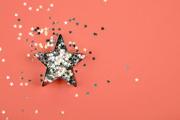 Star with sparkles and shape for gingerbread on Living Coral background. Color of the year 2019...