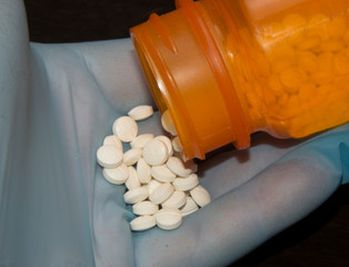 Pills held for inspection and to use as medicine.