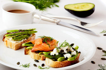 three bruschetta with avocado salmon and cheese