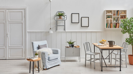 Decorative dining room and living room, white door, wooden wall, frame and lamp, armchair with coffee table and wooden dining table style. White shelf and home object.