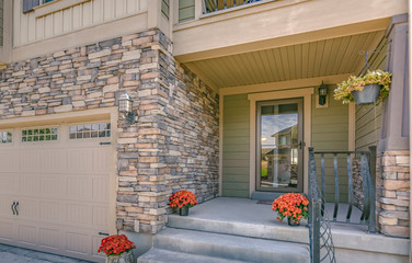 Stairs porch front door and garage of a home