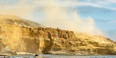 Steep cliff with dust against sky in La Jolla sea