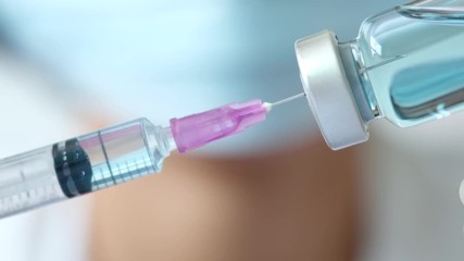 doctor uses a syringe to dispense medication from the bottle. at the hospital. Health and medical concepts - Powered by Adobe