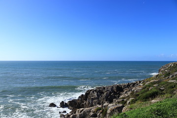 cliffs by the sea with blue sky