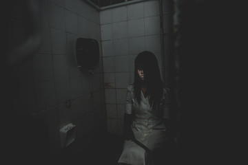 Portrait of asian woman make up ghost face with blood,Horror scene,Scary background,Halloween...