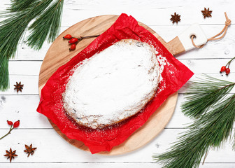 Traditional homemade Christmas stollen. German fruit bread with nuts, candied fruits, raisins and...