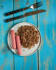 buckwheat, Bowl of tasty porridge on wooden table (breakfast), top view. copy space