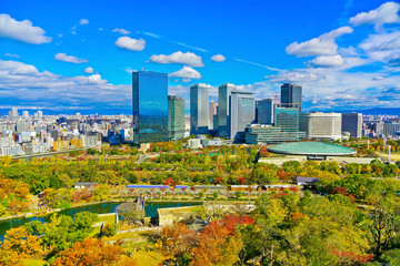 View of the Osaka Castle Park in autumn and city center in the background in Osaka, Japan.