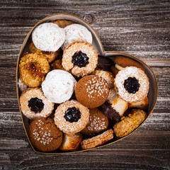 Valentines Day Card Background with Assorted Cookies over Wooden Background. Selective focus.
