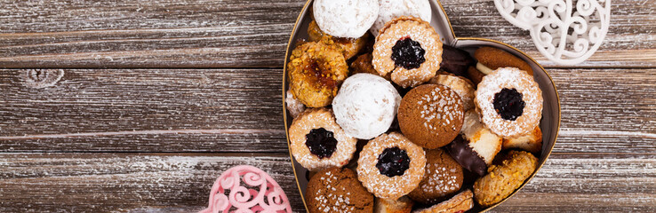 Valentines Day Card Background with Assorted Cookies over Wooden Background. Selective focus.
