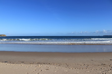 Fototapeta na wymiar beach of Gamboa in Peniche with blue sky in background