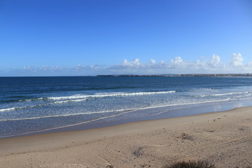 Fototapeta na wymiar beach of gâmboa in Peniche with sand and cloudy sky in the background