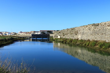 Fototapeta na wymiar old fort in the water with bridge in the background