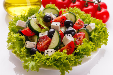 Greek salad on a white acrylic background