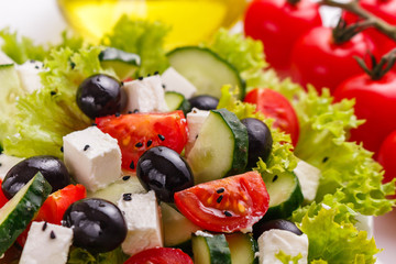 Greek salad on a white acrylic background