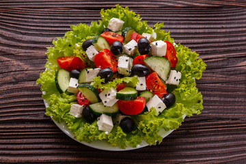 Greek salad on a wooden rustic background