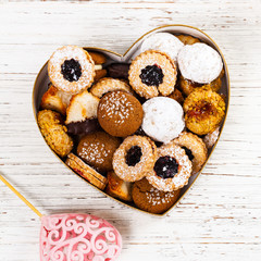 Valentines Day Card Background with Assorted Cookies over Wooden Background. Selective focus.