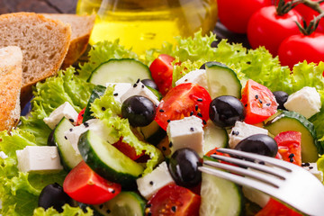 Greek salad on a wooden rustic background