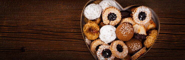 Valentines Day Card Background with Assorted Cookies over Wooden Background. Selective focus.