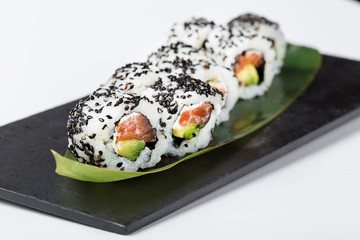 Fresh uramaki shushi rolls with black seeds