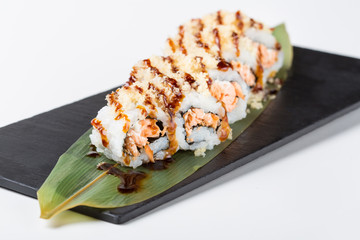 Set of uramaki sushi served on green leaf