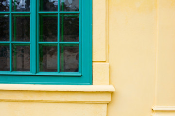 Fototapeta na wymiar facede of old european house in yellow and turquoise colors