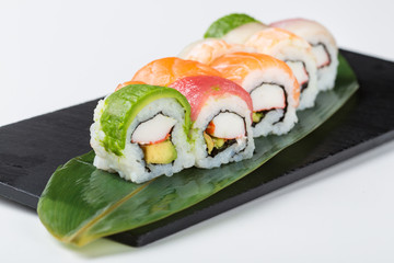 Set of colorful sushi rolls served on leaf