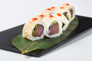 Uramaki sushi with seeds and red sauce