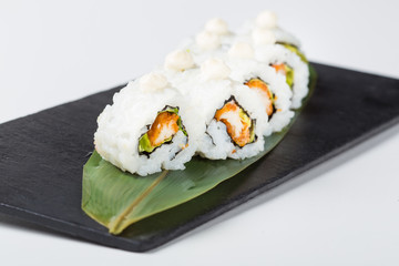 Fresh uramaki sushi rolls served on leaf