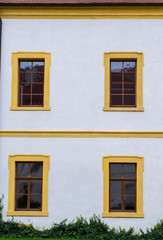Fototapeta na wymiar facade of an old german house with wooden windows and white walls
